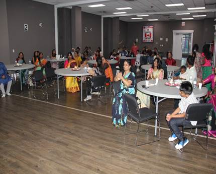 A group of people sitting at tables
AI-generated content may be incorrect.