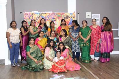 A group of women in traditional dresses posing for a photo
AI-generated content may be incorrect.