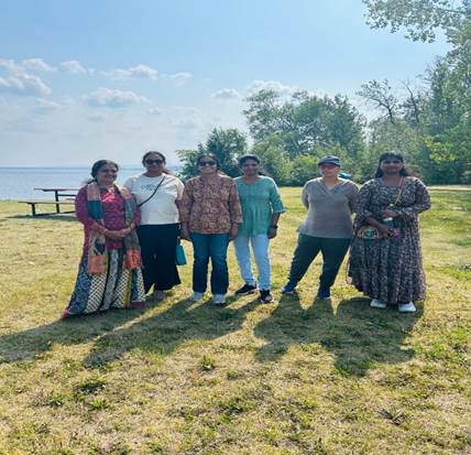 A group of women standing in a field
AI-generated content may be incorrect.